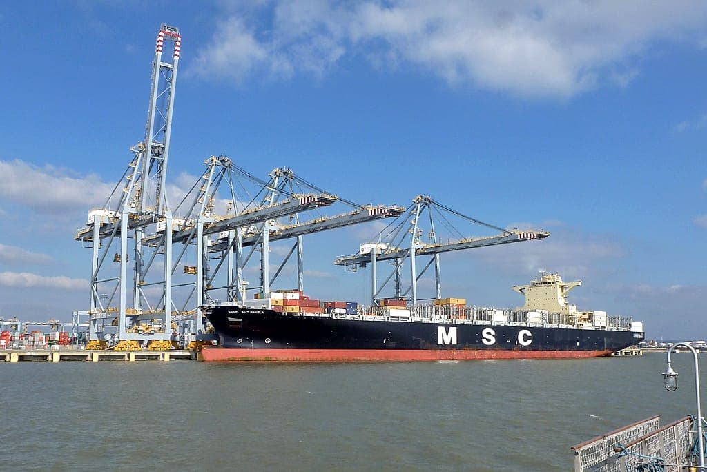 Container vessel under quay cranes at London Gateway port, United Kingdom
